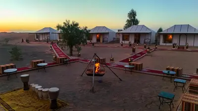 a group of lodges in the middle of a desert at Arabian Nights Desert Camp Merzouga in Lac Yasmins