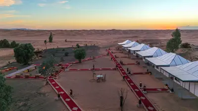 an aerial view of a desert with many tents at Arabian Nights Desert Camp Merzouga in Lac Yasmins