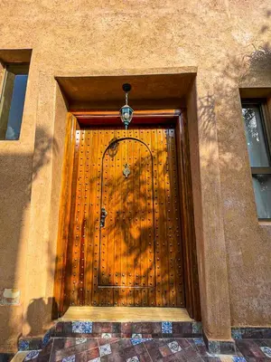 a large wooden door on a building at Villa à ourika, piscine et montagnes, 40 min Marrakech in Ourika