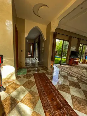 a living room with a checkered floor and a large rug at Villa à ourika, piscine et montagnes, 40 min Marrakech in Ourika