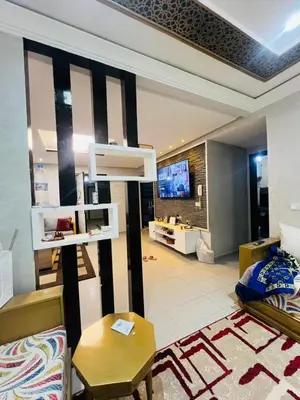 a living room with a couch and a tv at Appartement lux meublé in Ouarzazate
