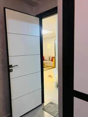 a door leading into a room with a living room at Appartement lux meublé in Ouarzazate
