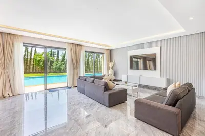 a living room with two couches and a pool at Villa Maryam , Élégance et calme & piscine privée in Marrakech