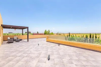 a patio with a couch and chairs on a roof at Villa Maryam , Élégance et calme & piscine privée in Marrakech