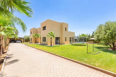 a house with a playground in front of it at Villa Maryam , Élégance et calme & piscine privée in Marrakech