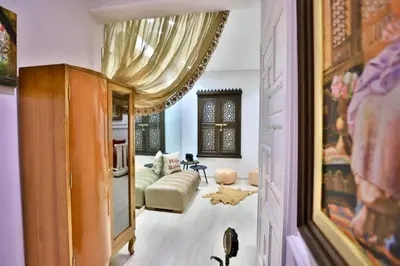 a living room with a curtain and a couch at Charmant appartement avec Wifi in Fès