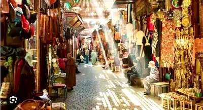 a group of people walking around a shop in a market at Charmant appartement avec Wifi in Fès