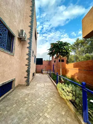 a brick walkway next to a building with a fence at Shams 2 in Sbiti