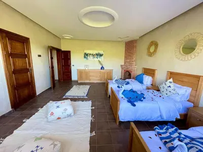 a hotel room with two beds and a bathroom at Shams 2 in Sbiti