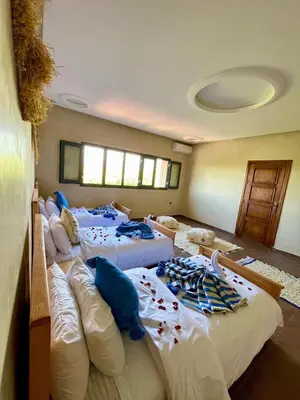 a group of four beds in a room at Shams 2 in Sbiti