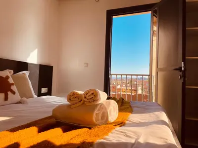 a bedroom with a bed with towels on it at ZyonFamily in Ouarzazate