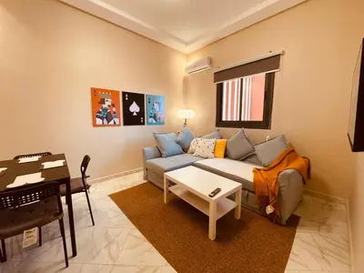 a living room with a couch and a piano at ZyonFamily in Ouarzazate