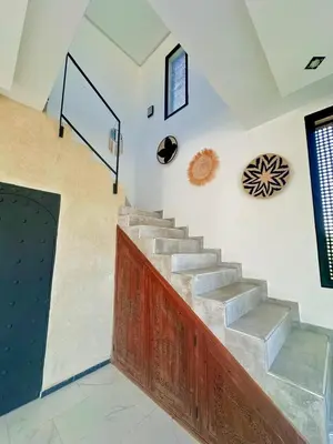 a set of stairs in a room with a door at Maison blanche in Sbiti