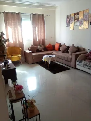 a living room with a couch and a table at Studio vacance in Oulad Akkou