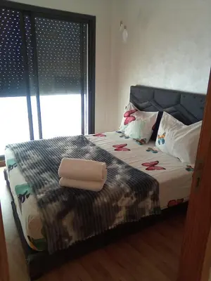 a bed with two towels on it in a bedroom at Studio vacance in Oulad Akkou