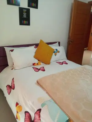 a bedroom with a bed with butterflies on it at Studio vacance in Oulad Akkou