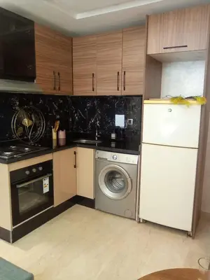 a kitchen with a washing machine and a washer at Studio vacance in Oulad Akkou