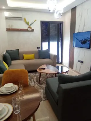 a living room with a couch and a table at Studio vacance in Oulad Akkou