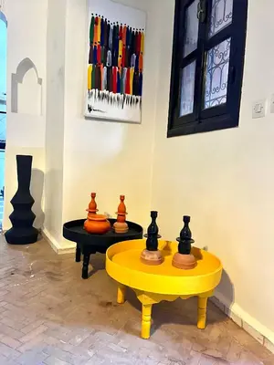 a room with a yellow table and some vases on it at Villa 4 chambres avec grande piscine privée in Marrakech