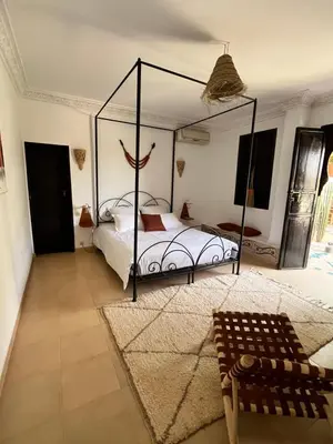 a bedroom with a canopy bed in a room at Villa 4 chambres avec grande piscine privée in Marrakech