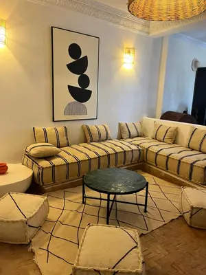 a living room with a couch and a table at Villa 4 chambres avec grande piscine privée in Marrakech