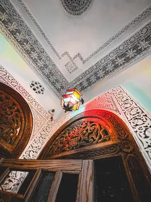 a ceiling with a chandelier on top of a door at Dar Roots Fes Ziat in Fès