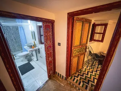a bathroom with a shower and a glass door at Dar Roots Fes Ziat in Fès