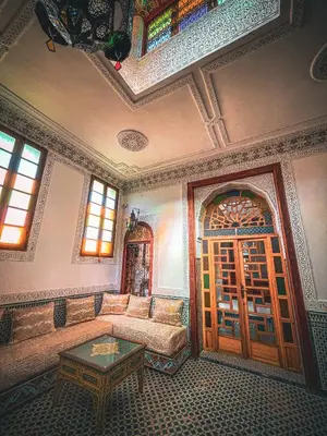a living room with a couch and a table at Dar Roots Fes Ziat in Fès