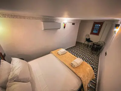 a small room with two beds in a room at Dar Roots Fes Ziat in Fès