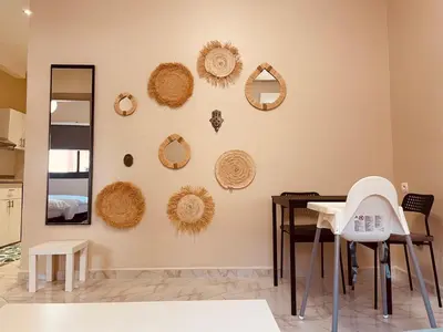 a dining room with a table and mirrors on the wall at Relax Family 05 - Cozy Entire Apartment in City Center in Ouarzazate