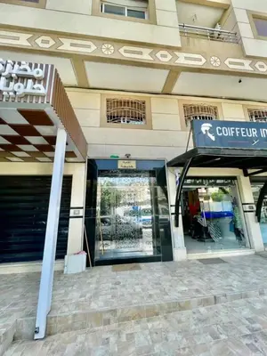 a store front of a building with a sign on it at Appartement de luxe à Tanger in Oulad Akkou