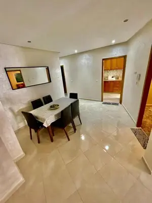 a dining room with a table and chairs at Appartement de luxe à Tanger in Oulad Akkou