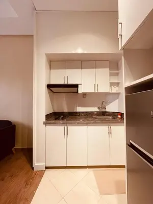 a kitchen with white cabinets and a stove top oven at Relax Family 04 - Cozy Entire Apartment in City Center in Ouarzazate