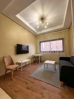 a living room with a couch and a tv at Relax Family 04 - Cozy Entire Apartment in City Center in Ouarzazate