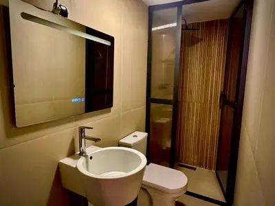 a bathroom with a sink and a toilet and a mirror at Relax Family 04 - Cozy Entire Apartment in City Center in Ouarzazate
