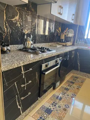 a kitchen with a sink and a stove top oven at arachidia in Beni Mellal