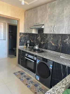 a kitchen with a stove and a dishwasher at arachidia in Beni Mellal