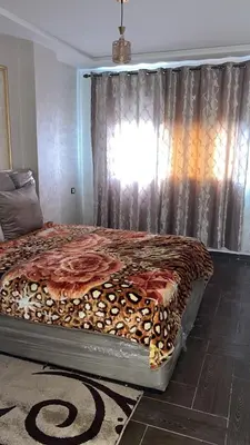a large bed in a bedroom with a window at arachidia in Beni Mellal