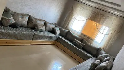 a couch in a living room with a window at arachidia in Beni Mellal