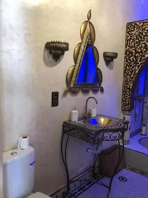 a bathroom with a sink and a toilet at Eden Suites