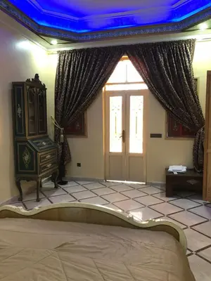 a bedroom with a bed and a blue ceiling at Eden Suites