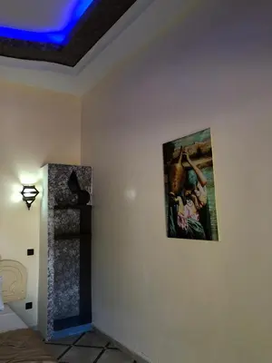 a room with a painting hanging on a wall at Eden Suites