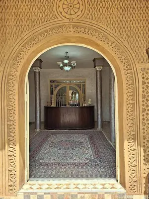 an archway in a room with a table and a rug at Eden Suites
