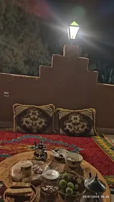 a living room with a table with food on it at Gite famille saghir in Skoura