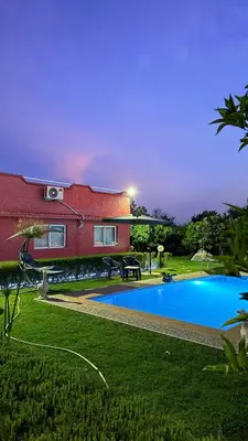 a house with a swimming pool in a yard at Villa Dayet Roumi House in Friday Market