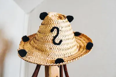 a straw hat with a bear on top of a wooden stand at Aisha VIP Camp in Merzouga