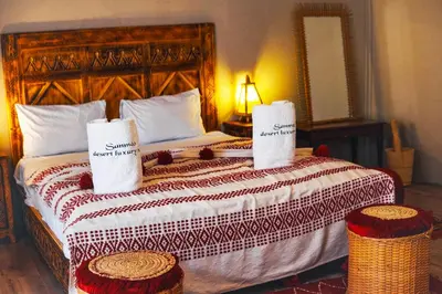 a bedroom with a bed with two towels on it at Aisha VIP Camp in Merzouga