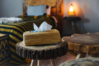 a room with a bed and a table with a box on it at Aisha VIP Camp in Merzouga