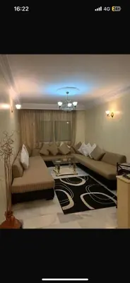 a living room with a couch and a table at residence le litoral 1 in Oulad Akkou