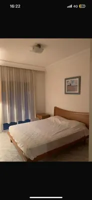 a bedroom with a bed and a window at residence le litoral 1 in Oulad Akkou